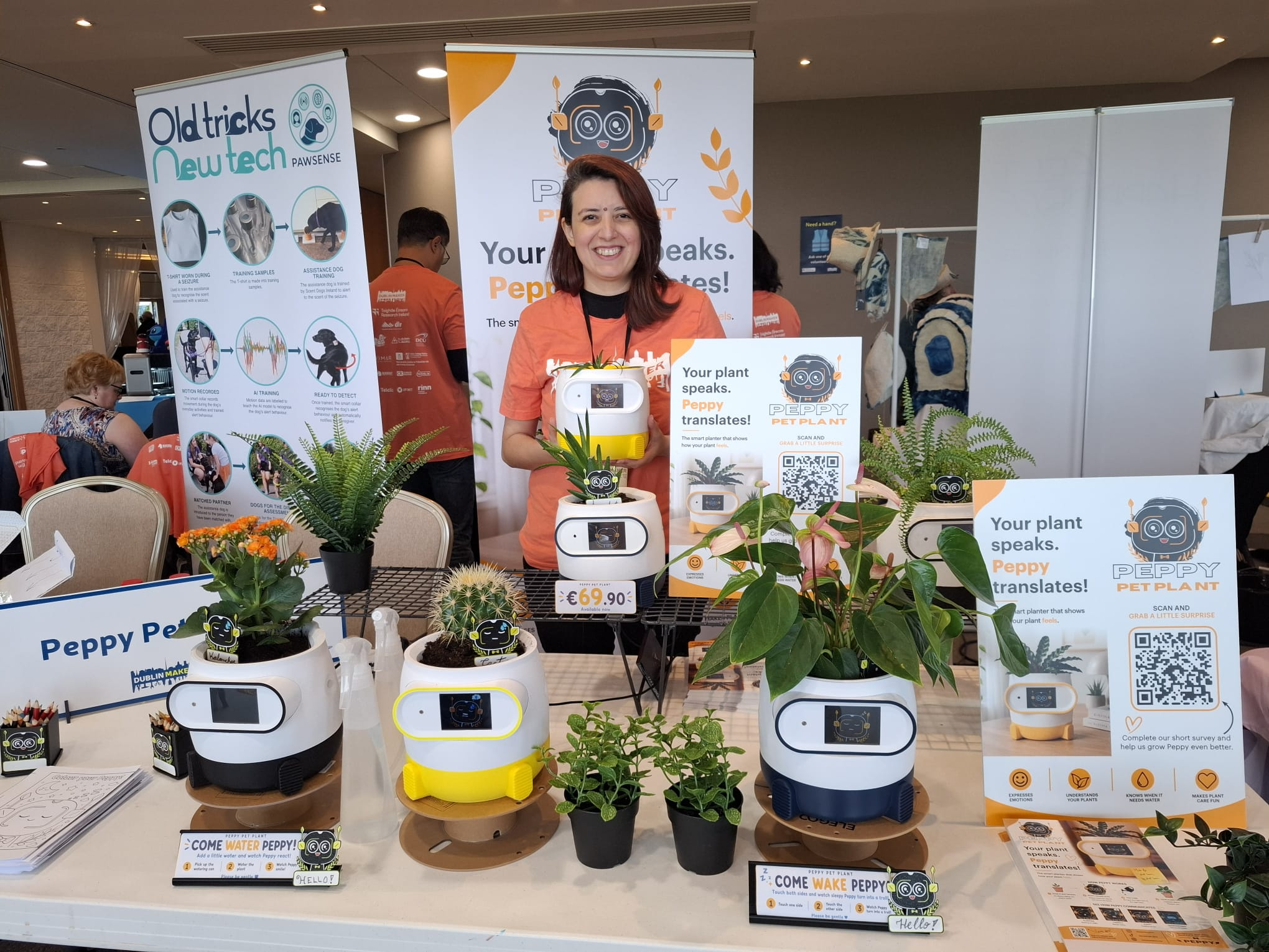 Peppy founder standing at the Dublin Maker stand with multiple Peppy planters on display